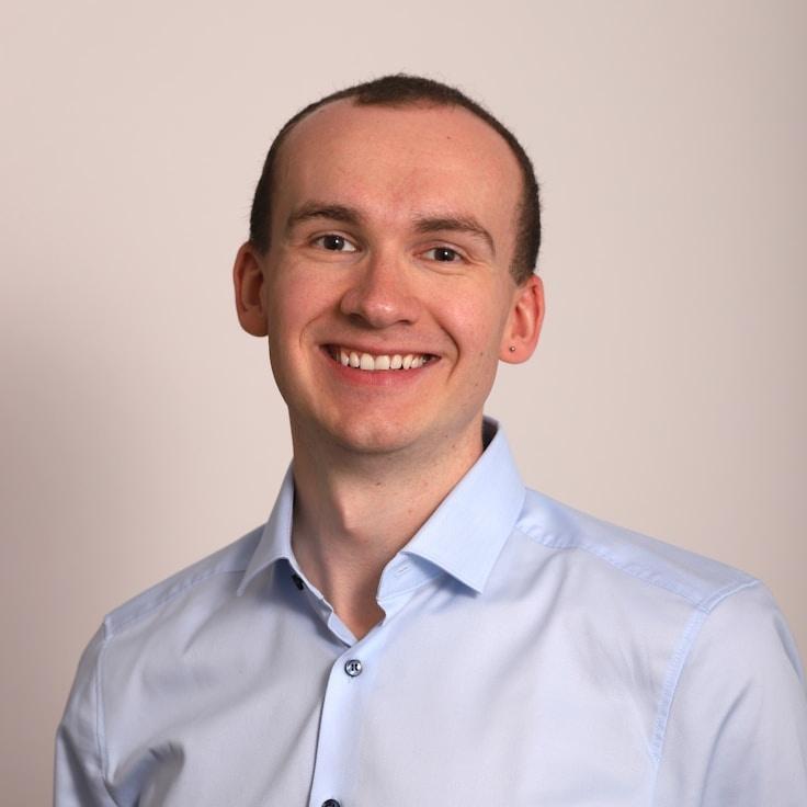 Ari Lin, Lead Design Curator at Modern Lifeequi Librium, reviewing corporate floral arrangements